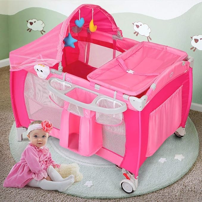 Costzon 4 in 1 Pink Pack and Play with Bassinet, Portable Baby Playard with Adjustable Canopy, Side Zipper Entrance, Music Box, Wheels/Brake, Foldable Infant Pink Bassinet for Baby Girl Toddlers